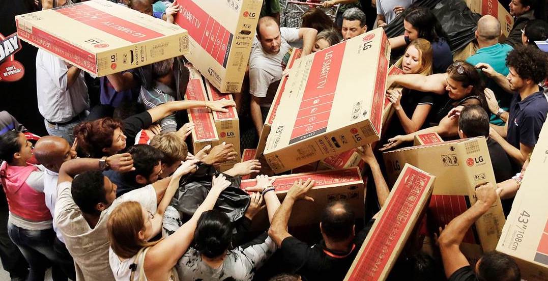 shoppers fight over cardboard boxes, illustrating the psychology of Black Friday in action